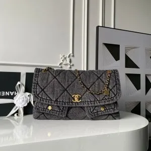 Chanel Maxi Flapbag in washed denim with gold-tone metal hardware